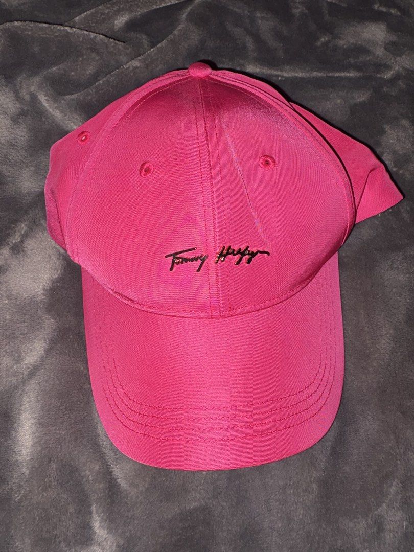 Tommy Hilfiger Pink Baseball Cap (Category: Caps & Hats) located in Manila. Submitted by scoobydoo_clothing (Listing ID 1462214225, Image 1). Description: - Classic pink Tommy Hilfiger baseball cap - Features an embroidered logo on the front - Adjustable strap at the back for a customized fit - Perfect for everyday casual wear.