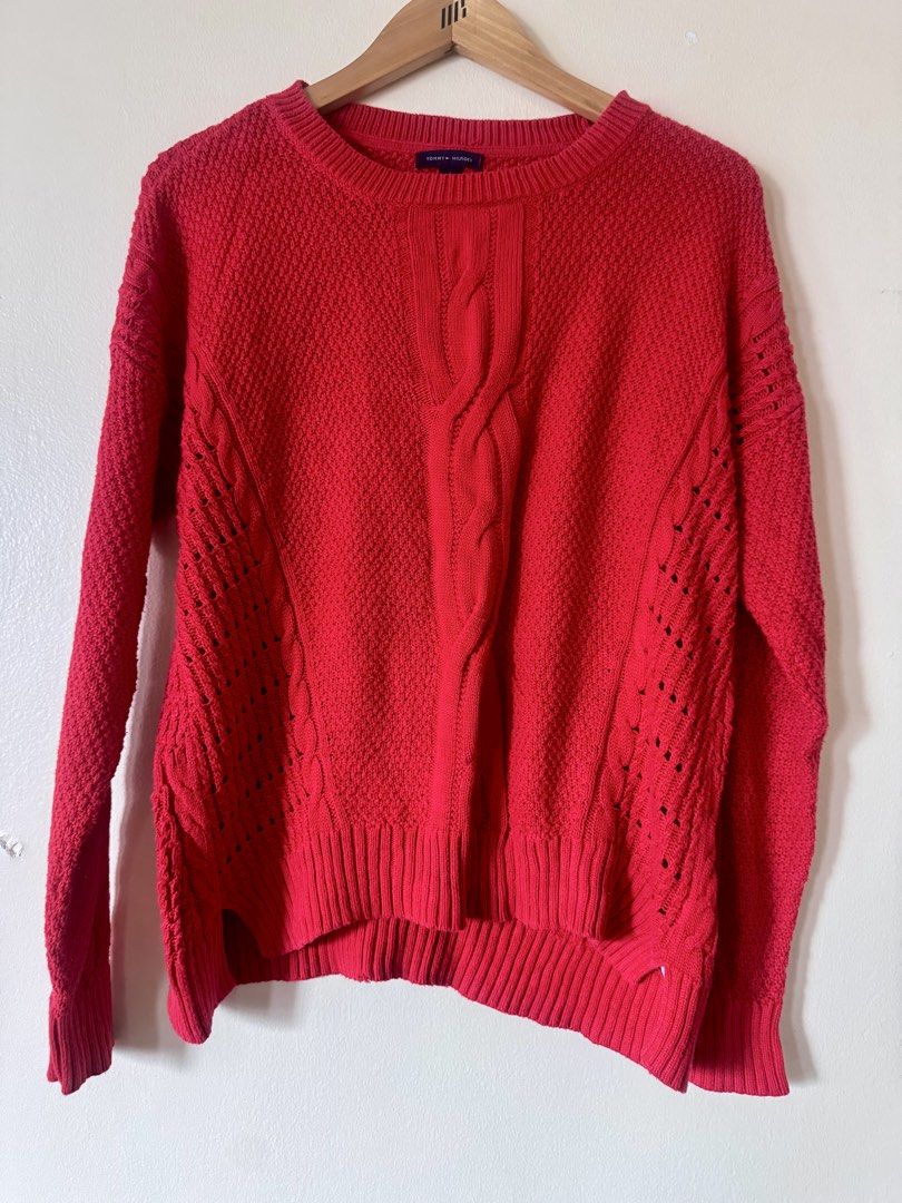 Tommy Hilfiger Red Cable Knit Sweater Size M (Category: Longsleeves) located in Paranaque City. Submitted by simplylizzy (Listing ID 1462075479, Image 1). Description: - Classic red Tommy Hilfiger sweater - Size: Medium - Cable knit design down the front - Textured knit all over - Open knit details on the sides - Crew neck, long sleeves - Ideal for layering or wearing solo.