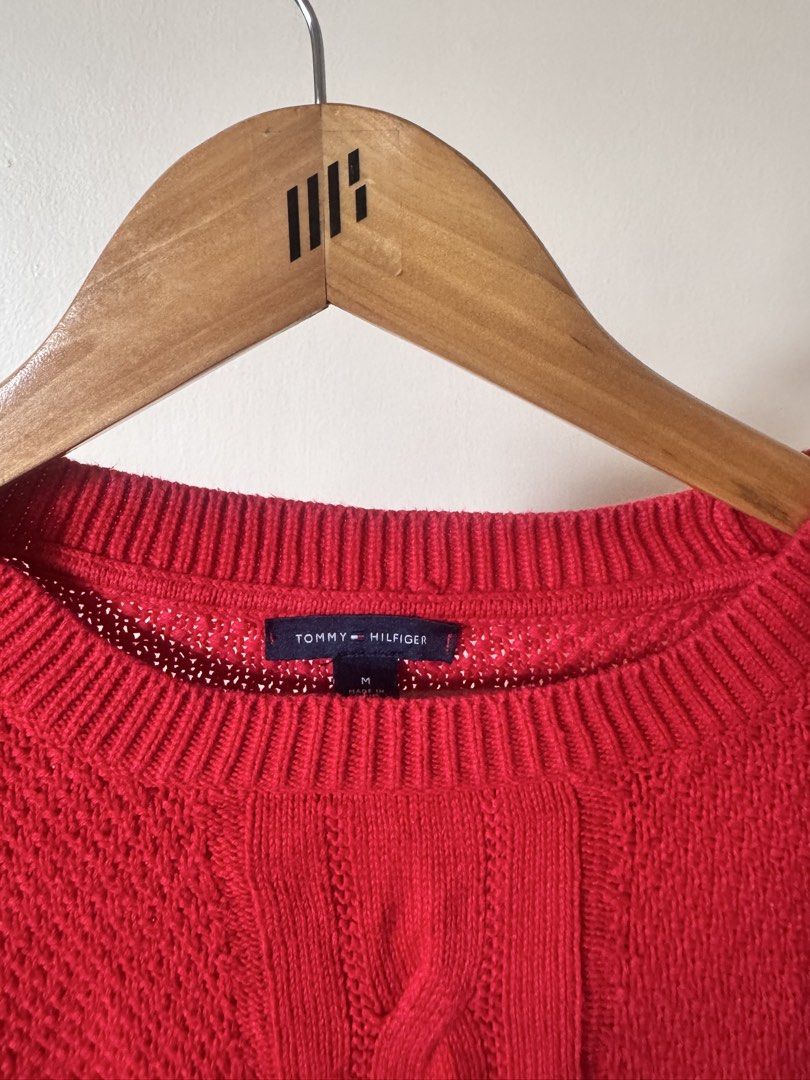 Tommy Hilfiger Red Cable Knit Sweater Size M (Category: Longsleeves) located in Paranaque City. Submitted by simplylizzy (Listing ID 1462075479, Image 2). Description: - Classic red Tommy Hilfiger sweater - Size: Medium - Cable knit design down the front - Textured knit all over - Open knit details on the sides - Crew neck, long sleeves - Ideal for layering or wearing solo.