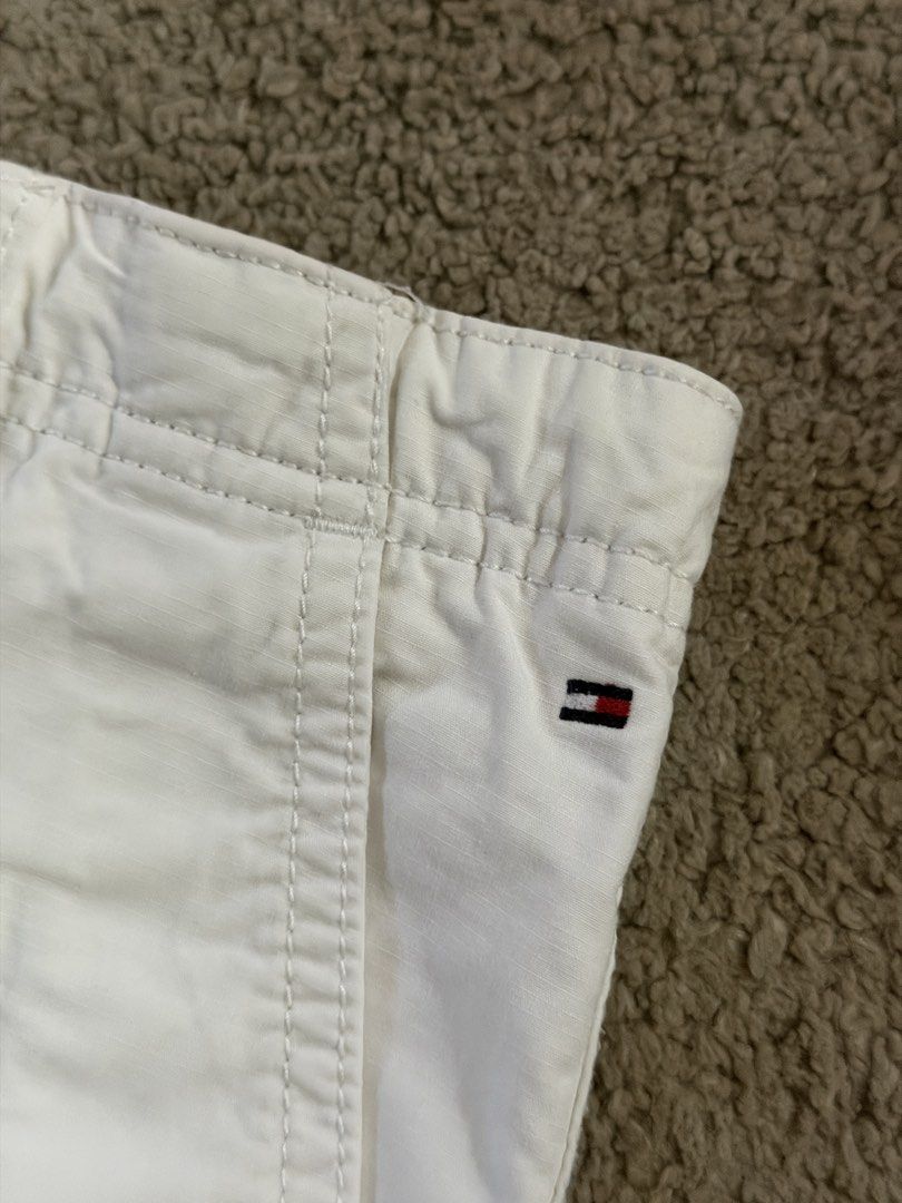 Tommy Hilfiger White Cargo Shorts Size 140 (Category: Babies & Kids Fashion) located in Quezon City. Submitted by _mgnmn (Listing ID 1462070067, Image 2). Description: - Brand: Tommy Hilfiger - Color: White - Style: Cargo Shorts - Size: 140 - Features: Elastic waistband with drawstring, front, back, and side pockets - Ideal for: Casual wear.