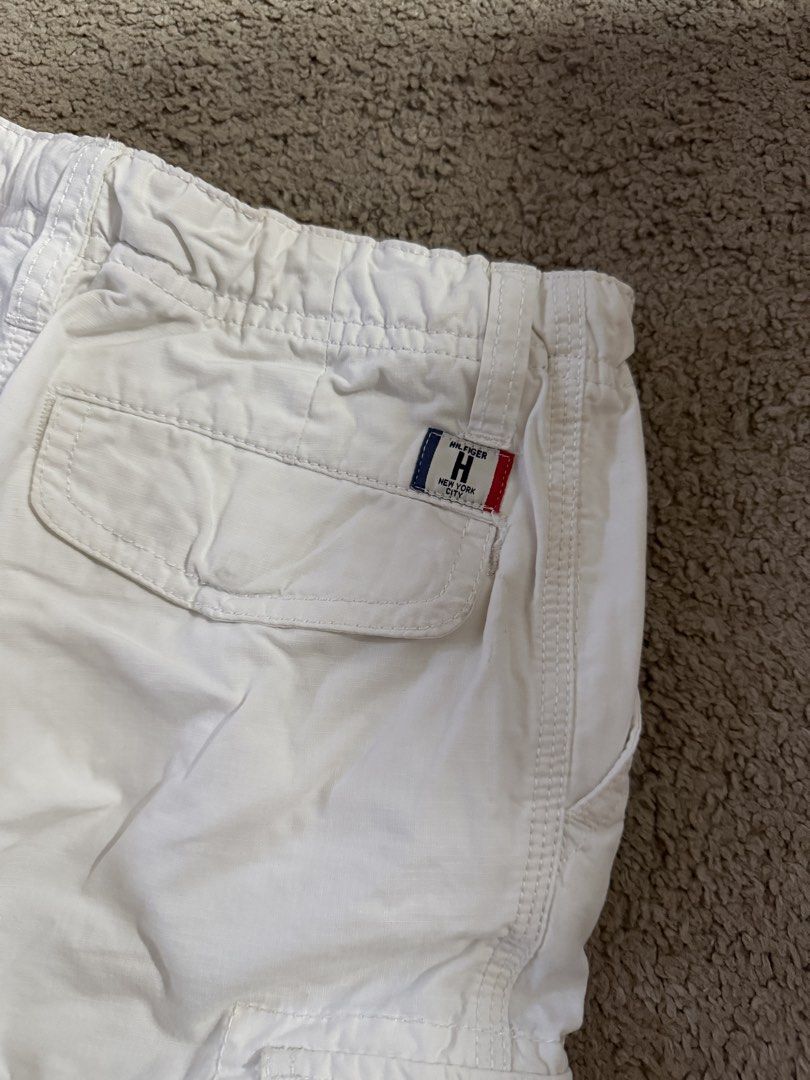Tommy Hilfiger White Cargo Shorts Size 140 (Category: Babies & Kids Fashion) located in Quezon City. Submitted by _mgnmn (Listing ID 1462070067, Image 3). Description: - Brand: Tommy Hilfiger - Color: White - Style: Cargo Shorts - Size: 140 - Features: Elastic waistband with drawstring, front, back, and side pockets - Ideal for: Casual wear.