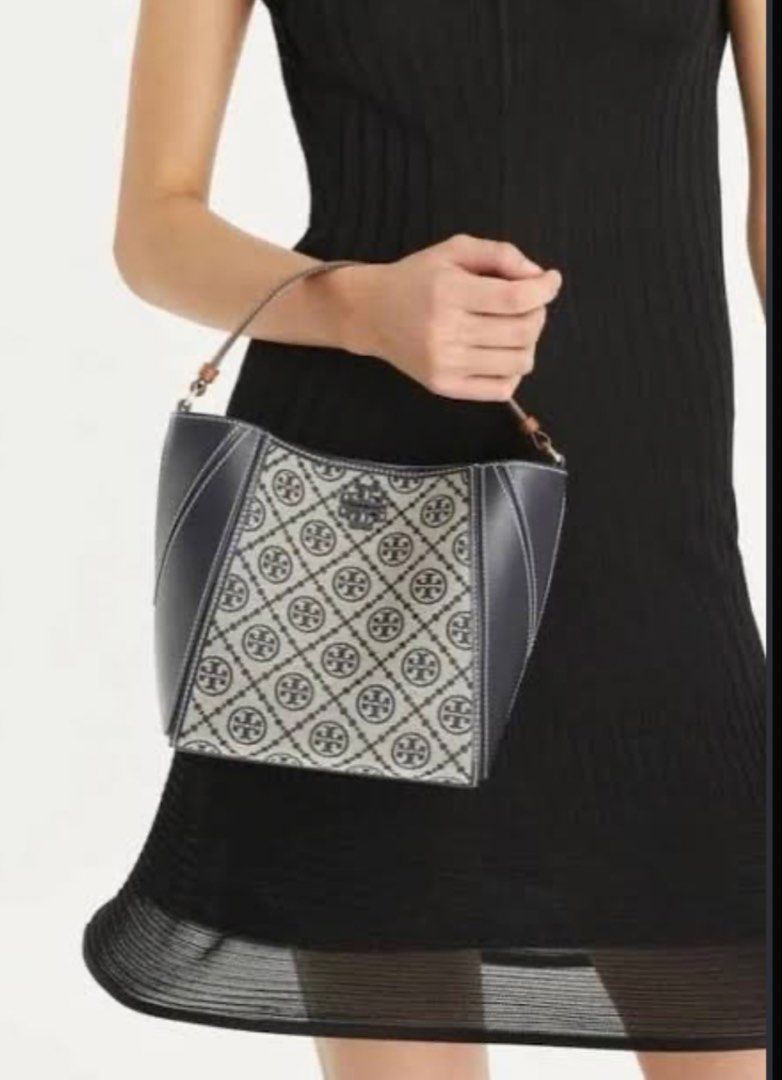 Tory Burch T Monogram McGraw Bucket Bag (Category: Luxury Bags & Wallets) located in Cebu City. Submitted by forless.ph (Listing ID 1462145900, Image 2). Description: Tory Burch tote bag. Features the classic monogram print with leather accents. The straps are brown leather. It has a structured shape and a top handle. Great for everyday use. Looks chic and stylish..