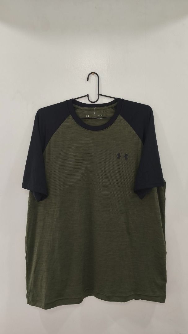 Under Armour (Category: Activewear) located in Quezon City. Submitted by secondtonone12 (Listing ID 1462136932, Image 1). Description: Style: Under Armour short-sleeve performance T-shirt with a raglan/color-block construction. Construction: Athletic-cut body with contrasting sleeves extending diagonally from the neckline into the underarm area. Lightweight, smooth performance fabric. Technology: HeatGear performance fabric, designed for lightwei
