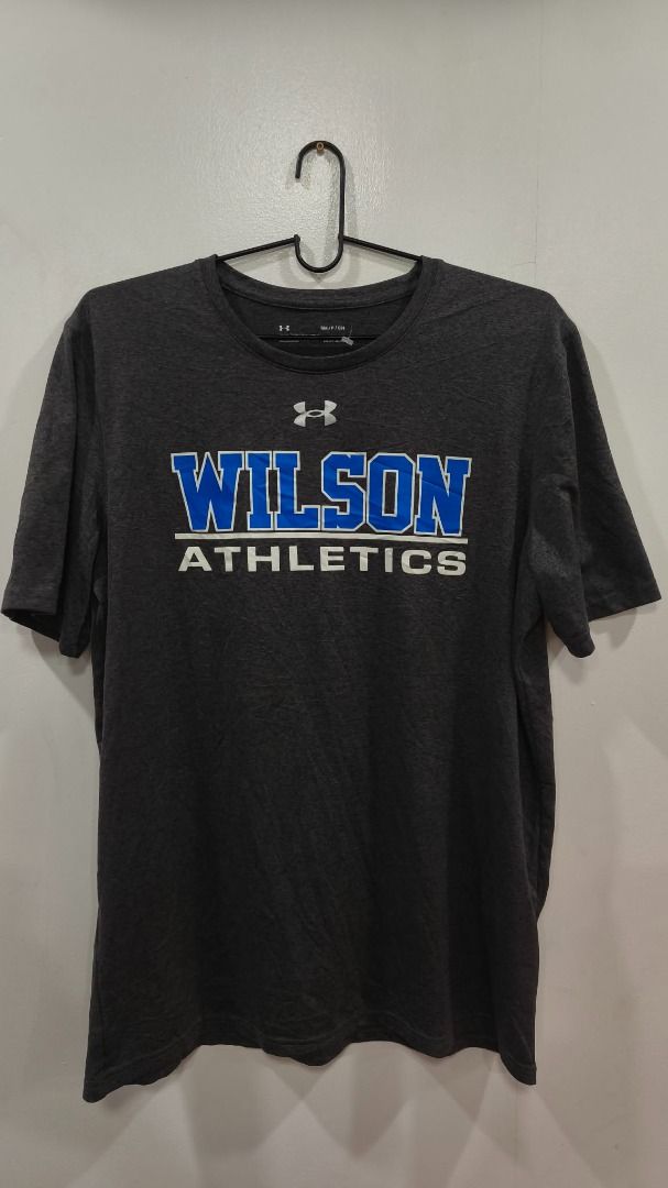 Under armour training tee (Category: Activewear) located in Quezon City. Submitted by secondtonone12 (Listing ID 1462041974, Image 1). Description: Brand: Under Armour Graphic: WILSON ATHLETICS in blue and white collegiate-style lettering. Color: Charcoal gray / dark heather. Style: Short-sleeve crew-neck athletic T-shirt..