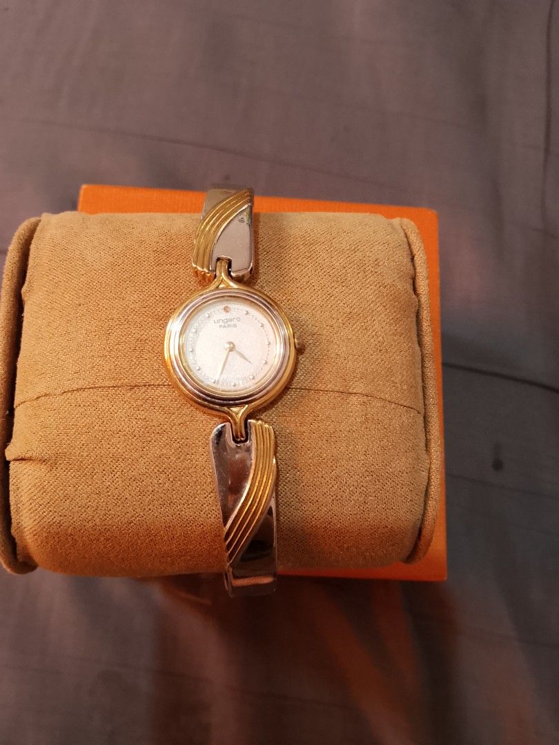Ungaro Watch Two Tone Bangle (Category: Women's Watches) located in Manila. Submitted by wildwind_73f77a (Listing ID 1461642560, Image 1). Description: - Authentic Ungaro watch - Elegant two-tone metal bangle (gold & silver accents) - Classic round face with a clean white dial - Versatile: perfect for everyday or special occasions - Fits most wrist sizes.