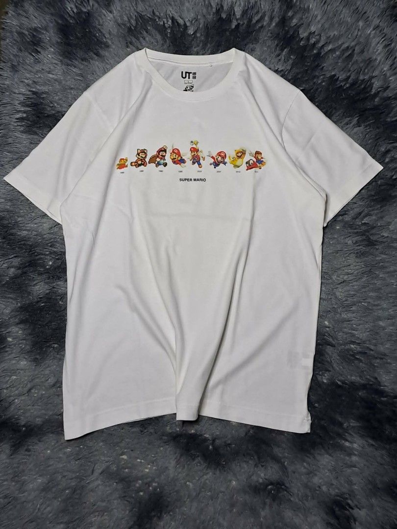 UT Uniqlo x Nintendo Mario Evolution (Category: Tshirts & Polo Shirts ) located in Manila. Submitted by yaseen__73 (Listing ID 1462216083, Image 1). Description: Uniqlo UT graphic t-shirt featuring a row of character sprites that show Mario's design evolution from 1985 to 2017 across the chest Wearing Size : Large on Tag Dimensions : See Photo Color Rate : 9.9/10 Flawless In Excellent Condition - PRE Owned MOP : G C A S H B A N K T R A N S F E R 