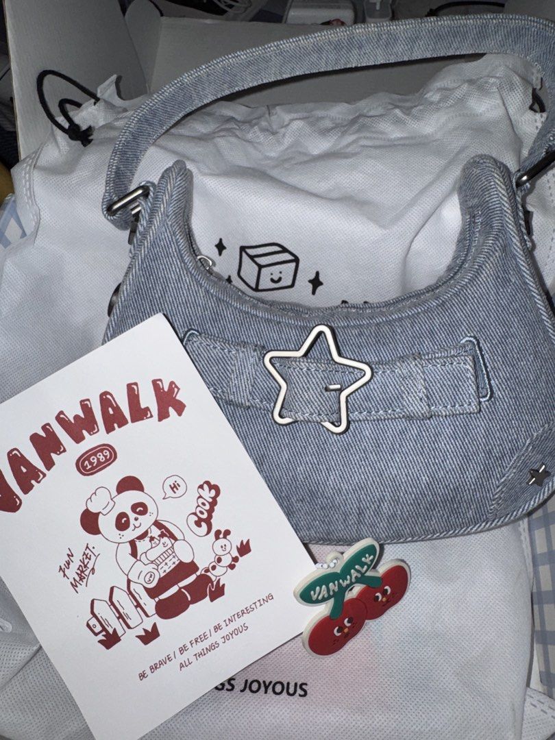 VANWALK Denim Shoulder Bag with Star Charm (Category: Shoulder Bags) located in Marikina City. Submitted by iyashells (Listing ID 1462080054, Image 1). Description: - Cute VANWALK denim shoulder bag - Features star and cherry charms - Comes with original dust bag and tag - Perfect for everyday use - Adds a fun touch to any outfit - issue: no zipper handle - price is still negotiable.