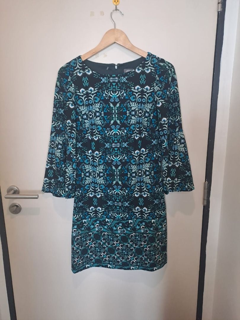 Vince Camuto dress (Category: Dresses) located in Mandaluyong City. Submitted by epicowl-c93c (Listing ID 1462220083, Image 1). Description: The image shows a Vince Camuto bell-sleeve dress featuring an intricate, symmetrical teal blue, green, and white floral damask pattern on a black background. The garment is crafted with a round neckline, a rear zipper closure, and is styled as a shift or A-line silhouette. med to large,.