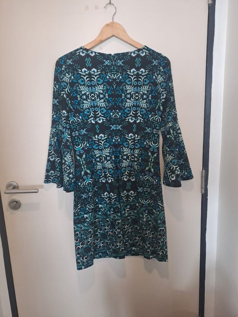 Vince Camuto dress (Category: Dresses) located in Mandaluyong City. Submitted by epicowl-c93c (Listing ID 1462220083, Image 2). Description: The image shows a Vince Camuto bell-sleeve dress featuring an intricate, symmetrical teal blue, green, and white floral damask pattern on a black background. The garment is crafted with a round neckline, a rear zipper closure, and is styled as a shift or A-line silhouette. med to large,.