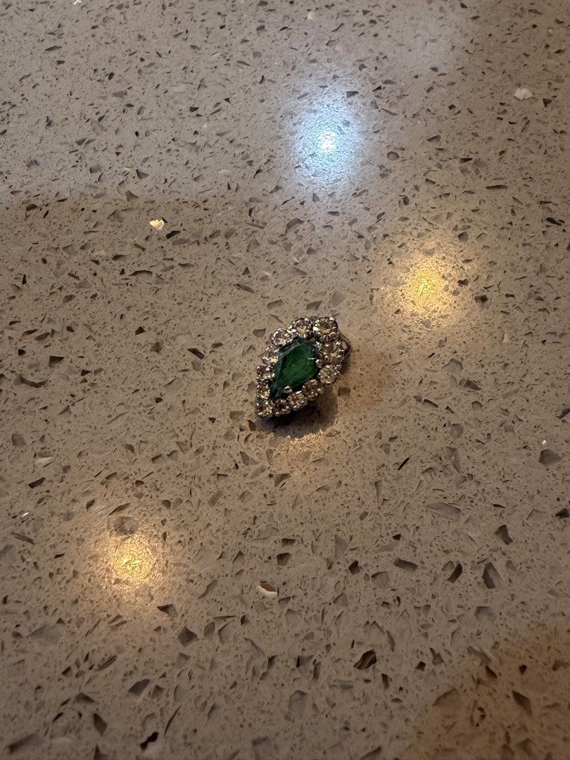 Vintage Christian Dior earring (Category: Earrings) located in Alfonso. Submitted by jbcamet (Listing ID 1462149617, Image 3). Description: - Elegant leaf-shaped brooch - Features a central green stone - Accented with sparkling clear rhinestones - Crafted with a silver-tone metal setting - Secure clasp closure on the back - Approximately 1 inch in length - Unique vintage find.