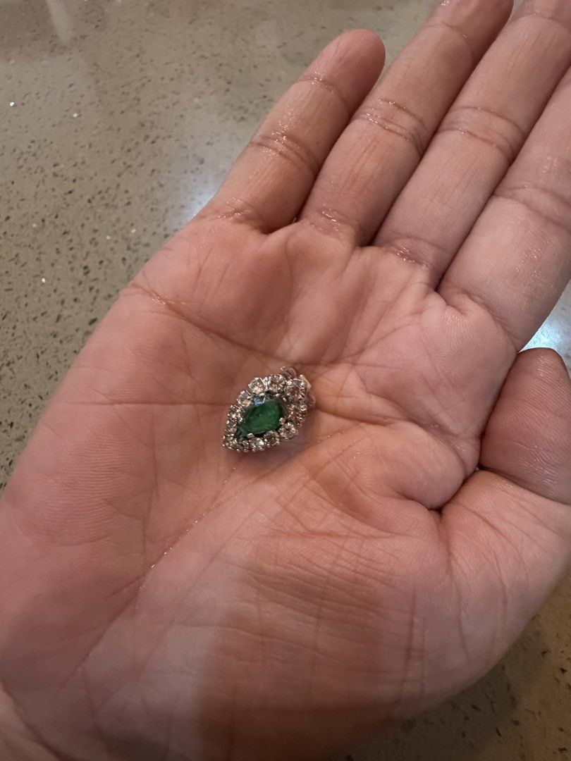 Vintage Christian Dior earring (Category: Earrings) located in Alfonso. Submitted by jbcamet (Listing ID 1462149617, Image 2). Description: - Elegant leaf-shaped brooch - Features a central green stone - Accented with sparkling clear rhinestones - Crafted with a silver-tone metal setting - Secure clasp closure on the back - Approximately 1 inch in length - Unique vintage find.