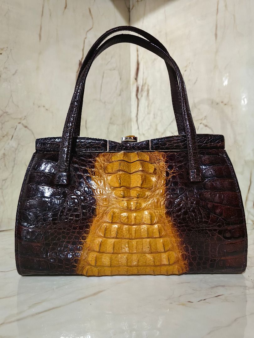 Vintage Crocodile Skin Handbag (Category: Luxury Bags & Wallets) located in Caloocan City. Submitted by jeremiah.curator.2026 (Listing ID 1462256656, Image 1). Description: - Genuine dark brown and tan crocodile skin - Unique color block design - Structured shape with secure clasp closure - Convenient top handles for carrying - Classic vintage statement piece.