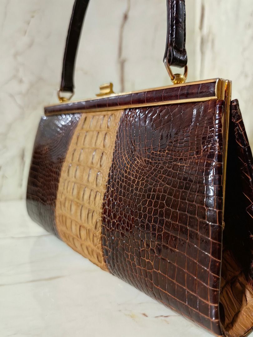 Vintage Crocodile Skin Handbag (Category: Luxury Bags & Wallets) located in Caloocan City. Submitted by jeremiah.curator.2026 (Listing ID 1462256799, Image 2). Description: - Genuine brown and tan crocodile skin handbag - Classic gold-tone frame closure - Interior zippered pocket and two open compartments - Crocodile skin handle - Unique vintage piece.