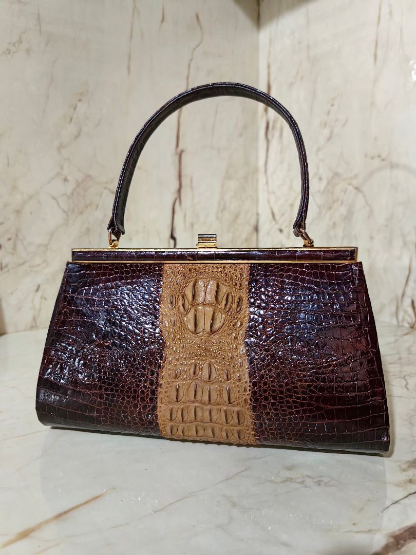 Vintage Crocodile Skin Handbag (Category: Luxury Bags & Wallets) located in Caloocan City. Submitted by jeremiah.curator.2026 (Listing ID 1462256799, Image 1). Description: - Genuine brown and tan crocodile skin handbag - Classic gold-tone frame closure - Interior zippered pocket and two open compartments - Crocodile skin handle - Unique vintage piece.