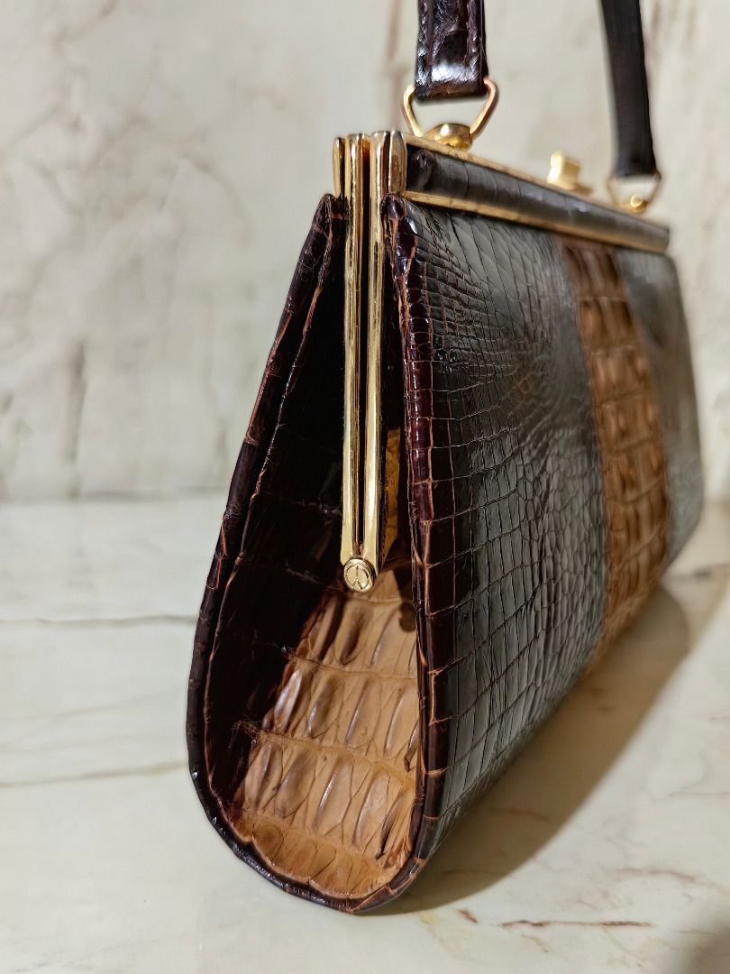 Vintage Crocodile Skin Handbag (Category: Luxury Bags & Wallets) located in Caloocan City. Submitted by jeremiah.curator.2026 (Listing ID 1462256799, Image 3). Description: - Genuine brown and tan crocodile skin handbag - Classic gold-tone frame closure - Interior zippered pocket and two open compartments - Crocodile skin handle - Unique vintage piece.