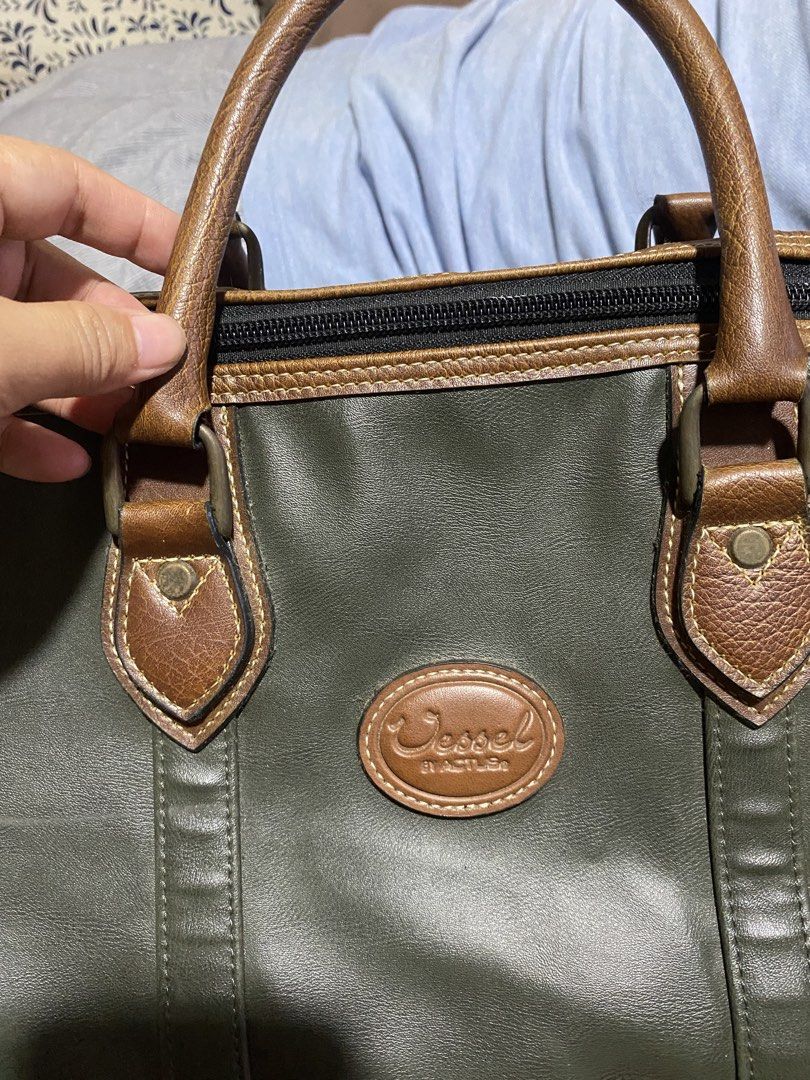 Vintage Ossel Leather Duffle Bag with Lock (Category: Luxury Bags & Wallets) located in Manila. Submitted by cdb_22 (Listing ID 1462226866, Image 2). Description: - Classic Ossel duffle bag - Color: Dark green with brown leather accents - Features: Main compartment and front zip pocket - Includes: Original lock and keys - Ideal for: Weekend trips or carry-on luggage.