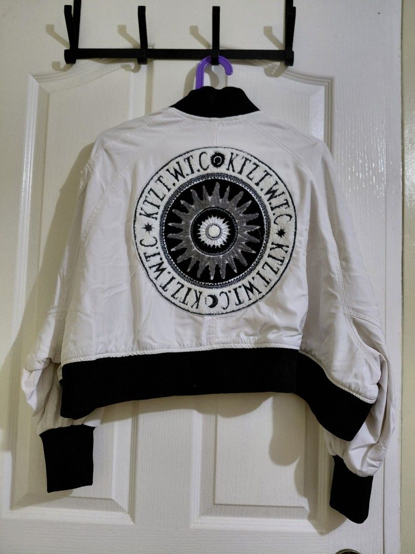 White Bomber Jacket with Black Accents (Category: Coats, Jackets and Outerwear) located in Manila. Submitted by plath-itudes (Listing ID 1462218709, Image 2). Description: high quality jacket for street fits! 🫶 - white bomber jacket - black ribbed cuffs and collar - very eye-catching design at the back 🤍 - two front pockets with button closures - zipper closure down the front size: can fit S-M, possibly L (baggy siya).