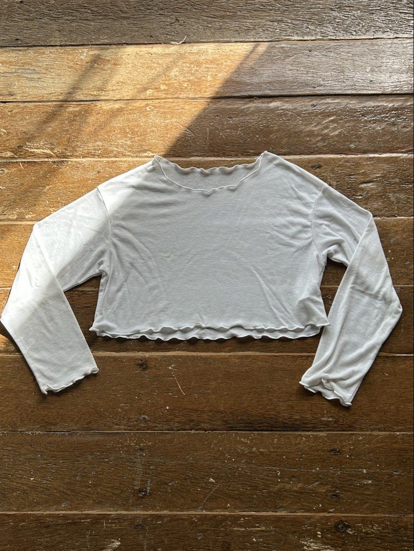 White Lettuce Hem Cropped Long Sleeve Top (Category: Longsleeves) located in Surigao. Submitted by chastnavarrete (Listing ID 1462223176, Image 1). Description: - White long sleeve crop top - Lettuce hem detail on neckline and hem - Lightweight fabric - Ideal for layering or wearing alone - Easy to pair with high-waisted bottoms.