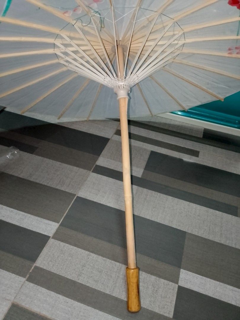 White Paper Umbrella with Floral Design (Category: Umbrellas) located in Manila. Submitted by bthriftmanila (Listing ID 1462078213, Image 3). Description: - Classic white paper umbrella with a parasol style. - Features a lovely hand-painted floral design in red, pink, and green. - Handle made of light wood. - Ideal for decorative purposes or as a photography/event prop. - Folds neatly for convenient storage..