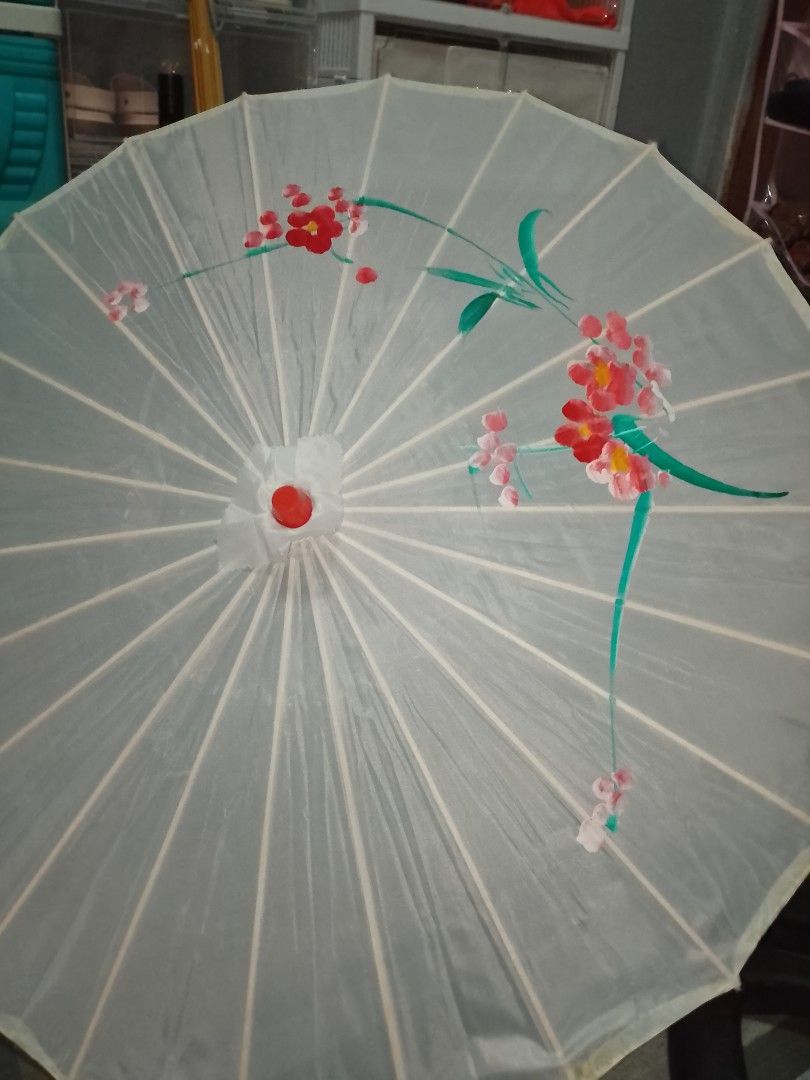 White Paper Umbrella with Floral Design (Category: Umbrellas) located in Manila. Submitted by bthriftmanila (Listing ID 1462078213, Image 2). Description: - Classic white paper umbrella with a parasol style. - Features a lovely hand-painted floral design in red, pink, and green. - Handle made of light wood. - Ideal for decorative purposes or as a photography/event prop. - Folds neatly for convenient storage..