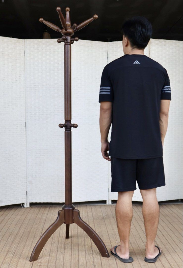 Wooden Coat Rack Stand with Hooks (Category: Shelves, Cabinets & Racks) located in Bulacan. Submitted by FurnitureGallery (Listing ID 1462257492, Image 2). Description: - Solid wood construction - Dark brown finish - Multiple hooks at the top for coats and hats - Additional smaller hooks lower down - Sturdy base for stability - Ideal for entryway or bedroom organization JAPAN SURPLUS FURNITURE WOODEN COAT RACK WITH 12HOOKS Size 21L x 68.5H in inc
