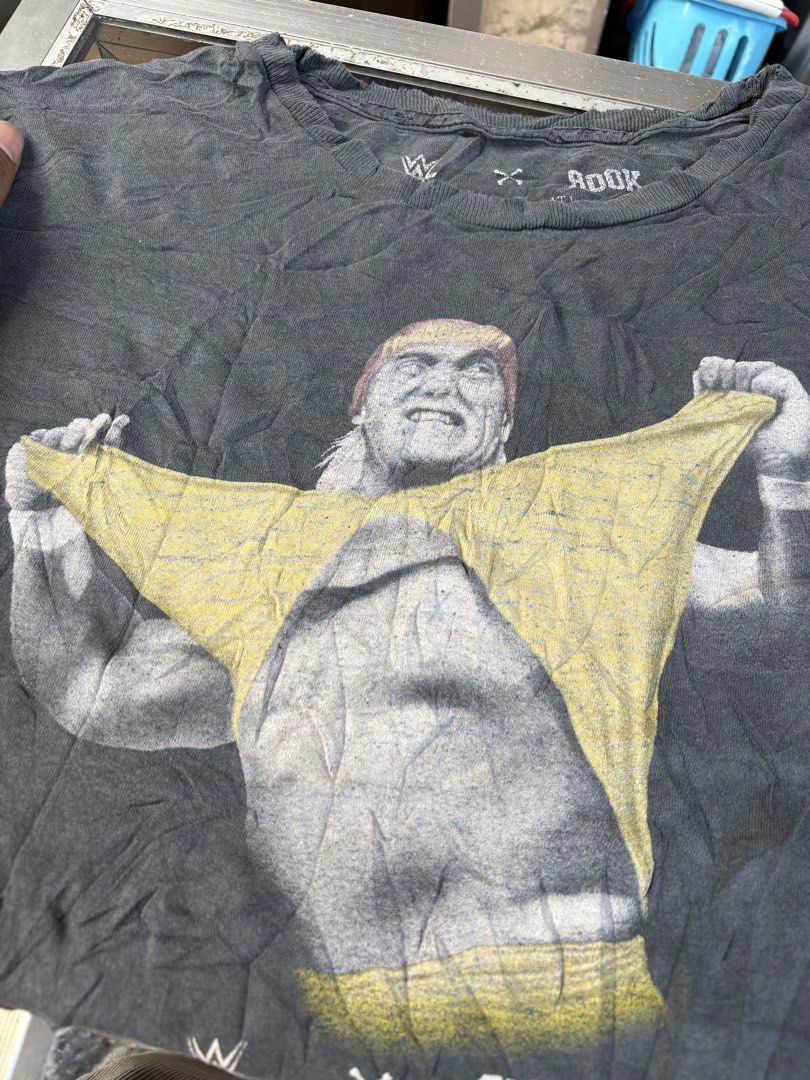 Wwe x rook (Category: Tshirts & Polo Shirts ) located in Tarlac. Submitted by jordan_1993 (Listing ID 1462096343, Image 2). Description: This appears to be a black WWE x Rook Hulk Hogan “Hulkamania” graphic tee featuring a vintage-style print of Hulk Hogan ripping his yellow shirt..