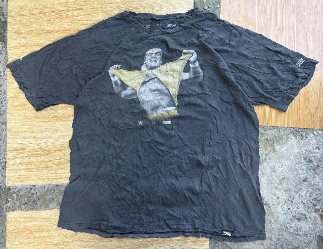Wwe x rook (Category: Tshirts & Polo Shirts ) located in Tarlac. Submitted by jordan_1993 (Listing ID 1462096343, Image 1). Description: This appears to be a black WWE x Rook Hulk Hogan “Hulkamania” graphic tee featuring a vintage-style print of Hulk Hogan ripping his yellow shirt..