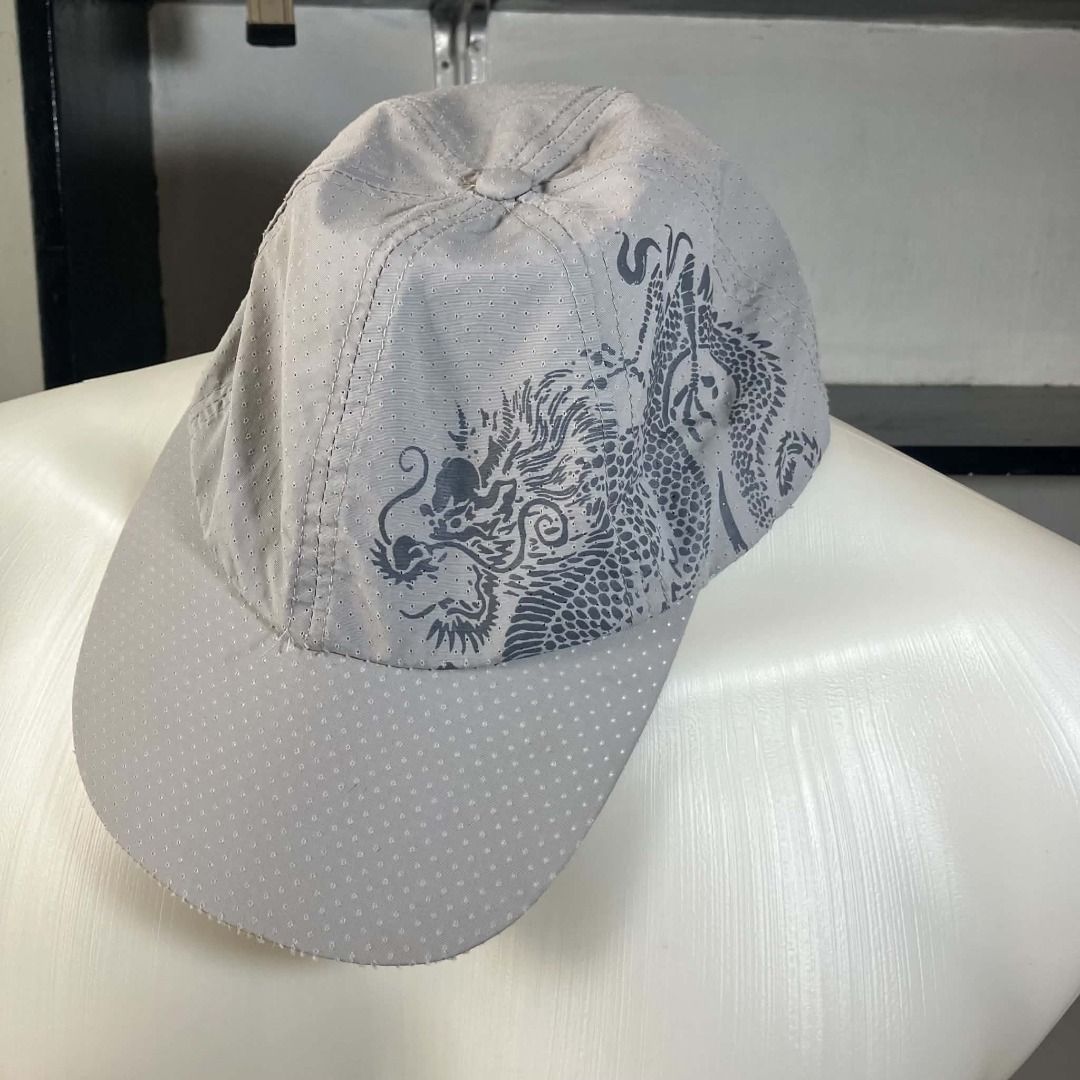 Y2K Breathable Perforated Grey Dragon Graphic Runner Cap (Category: Caps & Hats) located in Manila. Submitted by ninjadisplay (Listing ID 1462175621, Image 3). Description: * Brand: Unbranded / Generic * Style: Unstructured Runner Cap / Sporty Baseball Cap. Features a striking dark grey traditional dragon graphic printed across the front and side panels. * Material: Ultra-lightweight, breathable perforated micro-mesh fabric. Designed to keep your