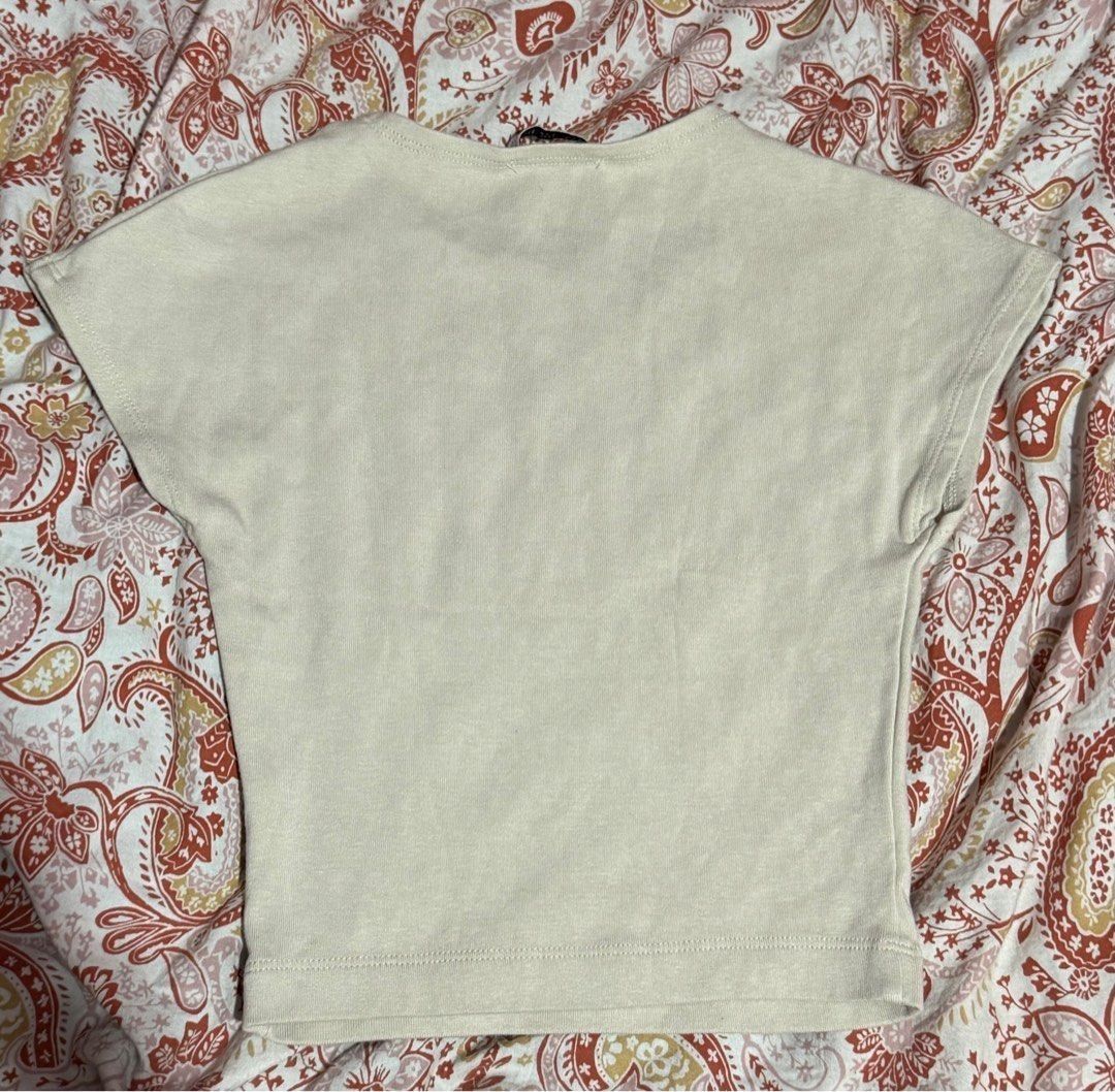 Zara Beige Crop Top (Category: Shirts) located in Binan City. Submitted by lexiieverse (Listing ID 1462221089, Image 2). Description: - Brand: Zara - Color: Beige - Style: Crop Top - Size: EUR S / USA S / MEX 26 - Material: Soft and comfortable fabric - Origin: Made in Bangladesh - Condition: Excellent, pre-loved - Features: Trendy cropped silhouette, versatile for various outfits.