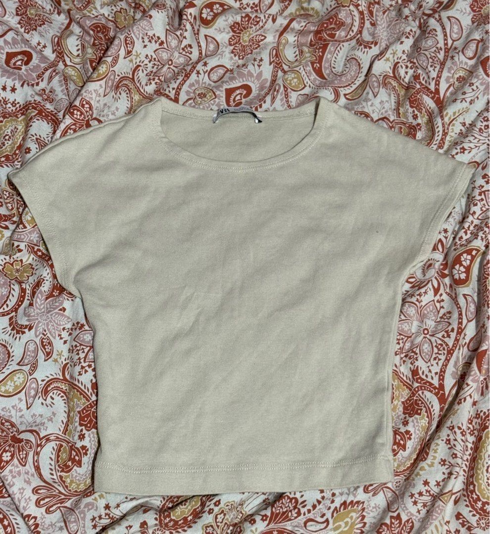 Zara Beige Crop Top (Category: Shirts) located in Binan City. Submitted by lexiieverse (Listing ID 1462221089, Image 1). Description: - Brand: Zara - Color: Beige - Style: Crop Top - Size: EUR S / USA S / MEX 26 - Material: Soft and comfortable fabric - Origin: Made in Bangladesh - Condition: Excellent, pre-loved - Features: Trendy cropped silhouette, versatile for various outfits.