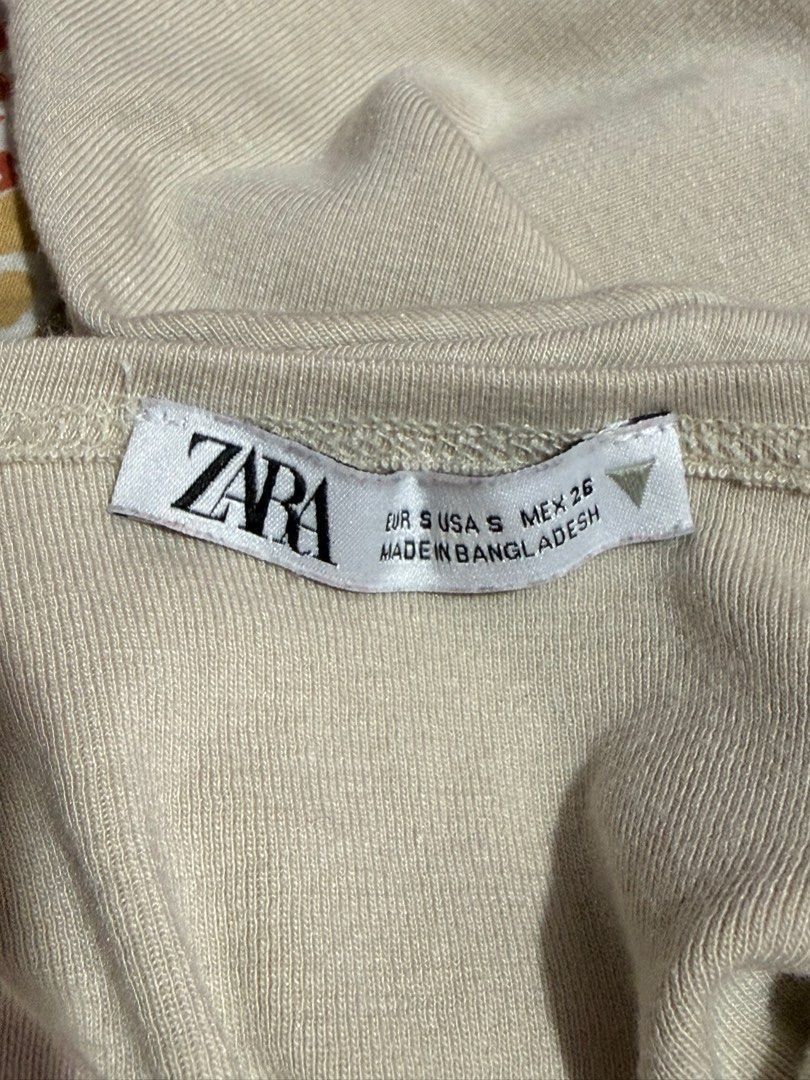 Zara Beige Crop Top (Category: Shirts) located in Binan City. Submitted by lexiieverse (Listing ID 1462221089, Image 3). Description: - Brand: Zara - Color: Beige - Style: Crop Top - Size: EUR S / USA S / MEX 26 - Material: Soft and comfortable fabric - Origin: Made in Bangladesh - Condition: Excellent, pre-loved - Features: Trendy cropped silhouette, versatile for various outfits.