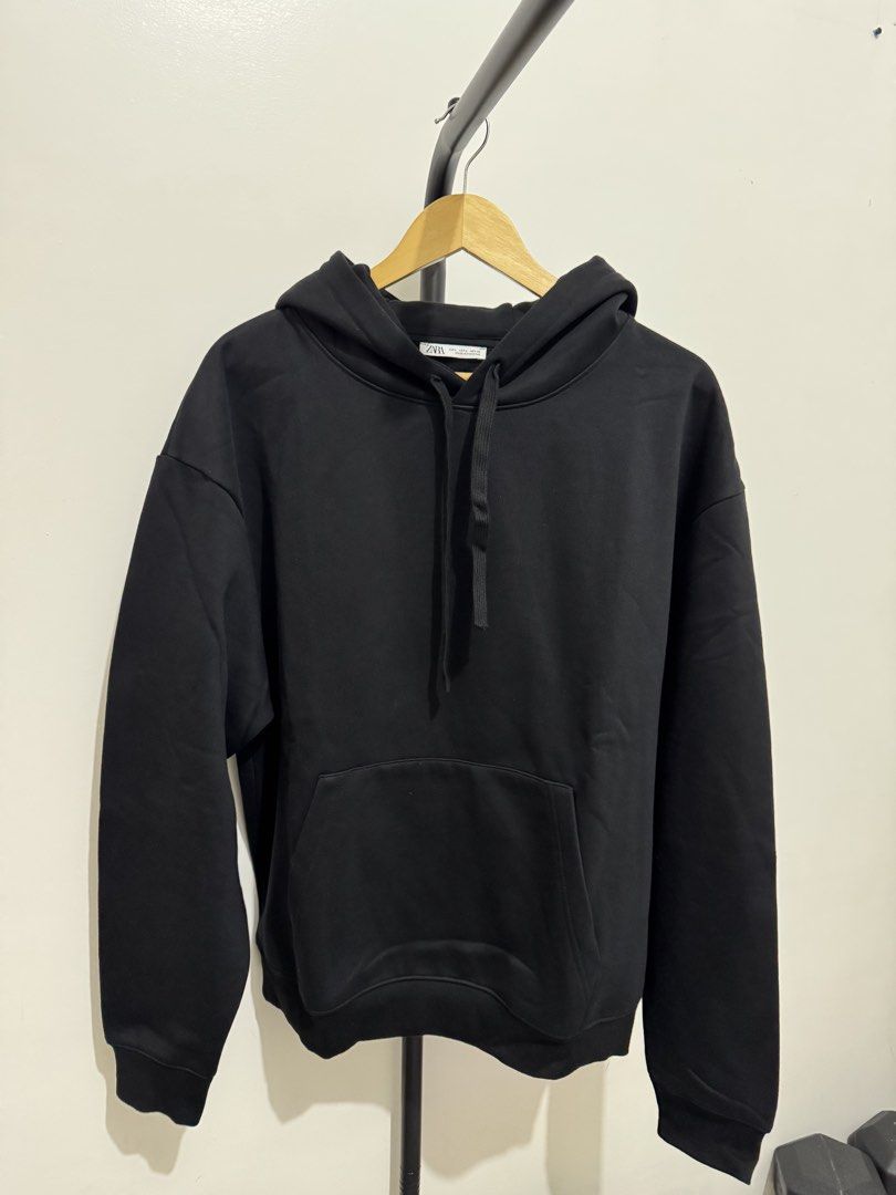 ZARA Black Hoodie Size L (Category: Hoodies) located in Mandaluyong City. Submitted by thewanderingmangyan (Listing ID 1462140464, Image 1). Description: - Classic black ZARA hoodie - Size: Large (L) - Features: Front pocket, adjustable drawstring hood - Comfort: Ribbed cuffs and hem - Origin: Made in Pakistan - Style: Great for casual wear or layering.