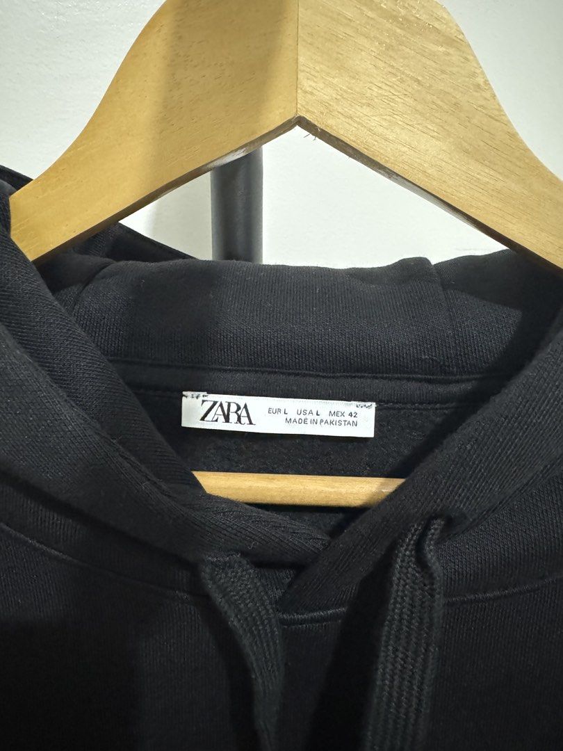 ZARA Black Hoodie Size L (Category: Hoodies) located in Mandaluyong City. Submitted by thewanderingmangyan (Listing ID 1462140464, Image 2). Description: - Classic black ZARA hoodie - Size: Large (L) - Features: Front pocket, adjustable drawstring hood - Comfort: Ribbed cuffs and hem - Origin: Made in Pakistan - Style: Great for casual wear or layering.