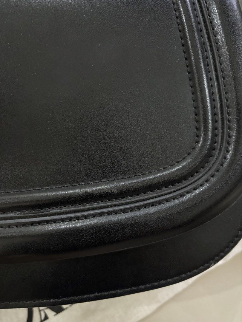 Zara Black Saddle Bag with Wide Strap (Category: Shoulder Bags) located in Bulacan. Submitted by janeeeeelleeeee (Listing ID 1462217826, Image 2). Description: Zara black saddle bag. Comes with a wide beige and black strap. Gold hardware details. Interior has a zip pocket. Dust bag included. I still have the tag. Mall-bought for 2595. May non-visible flaws na po (see photo).