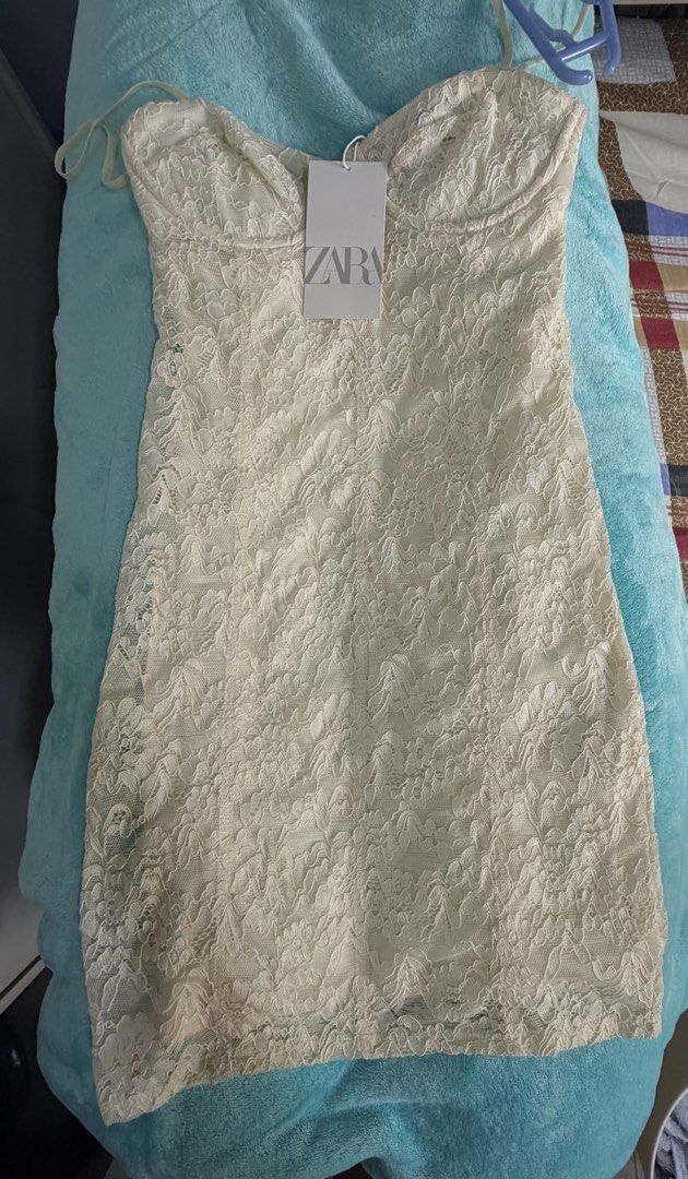 Zara lace mini dress (Category: Dresses) located in Taguig. Submitted by aileenraymnd (Listing ID 1462095049, Image 2). Description: Brand new Zara lace mini dress in cream/off-white with underwire bustier detail. IMPORTANT PLEASE READ!! Condition: New with tag but has two minor flaws noted in the close-up photos: - Slight fraying/loose thread at the center front bust wire. - A small loose seam/thread near the top back edge. - Runs small RFS : do