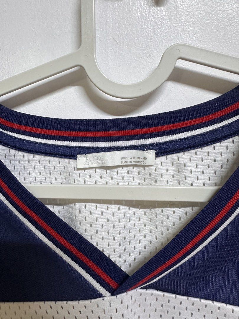 Zara Retro Mesh “Champs Triumph” Jersey (Category: Tshirts & Polo Shirts ) located in Manila. Submitted by nicholazvenzzz (Listing ID 1462168570, Image 3). Description: Zara Retro Technical Mesh Champs Triumph Jersey (Size M) Loose & Drop-Shoulder Fit Streetwear Vibes Material: Technical Mesh Fabric Chest: 37–38.5 inches Shoulder: ~17–17.5 inches Length: ~27.5–28 inches RFS: Tambak, needs wash only, issue is may small orange stain sa baba pero po