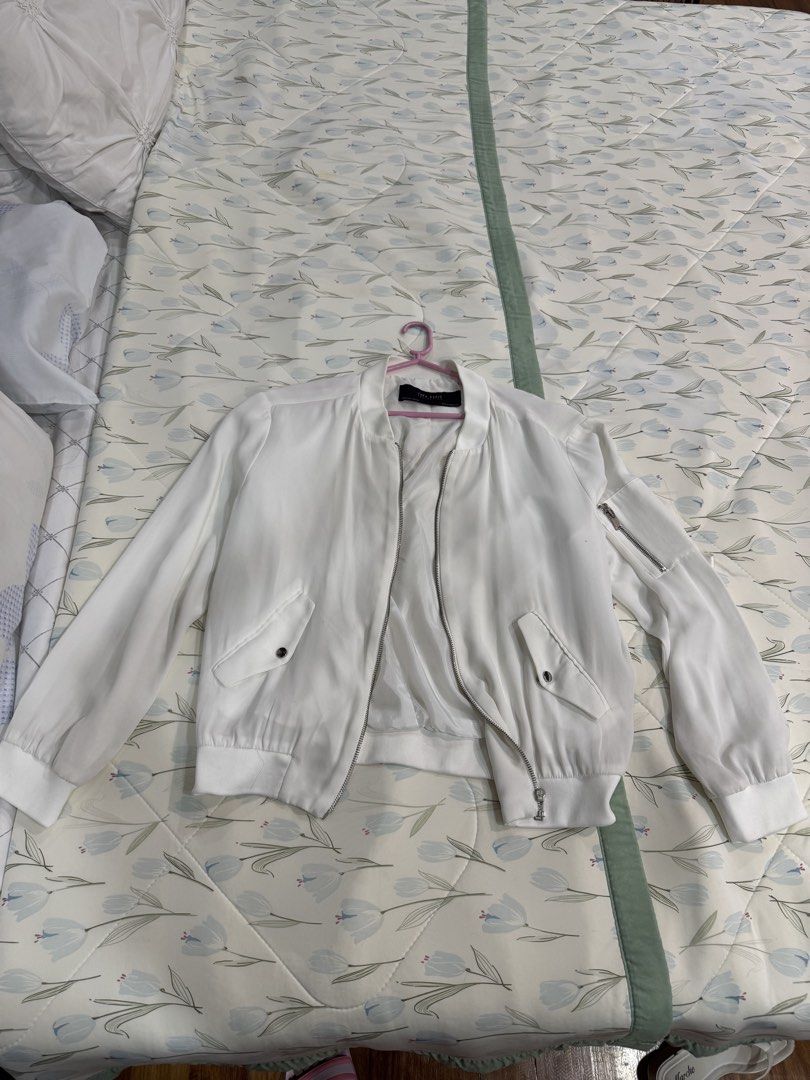 Zara White Bomber Jacket with Zipper Details (Category: Coats, Jackets and Outerwear) located in Quezon City. Submitted by ybonchon (Listing ID 1462172122, Image 2). Description: - Classic white bomber jacket - Zipper details on sleeves - Two front pockets with snap closures - Ribbed cuffs and hem - Ideal for layering and versatile styling.