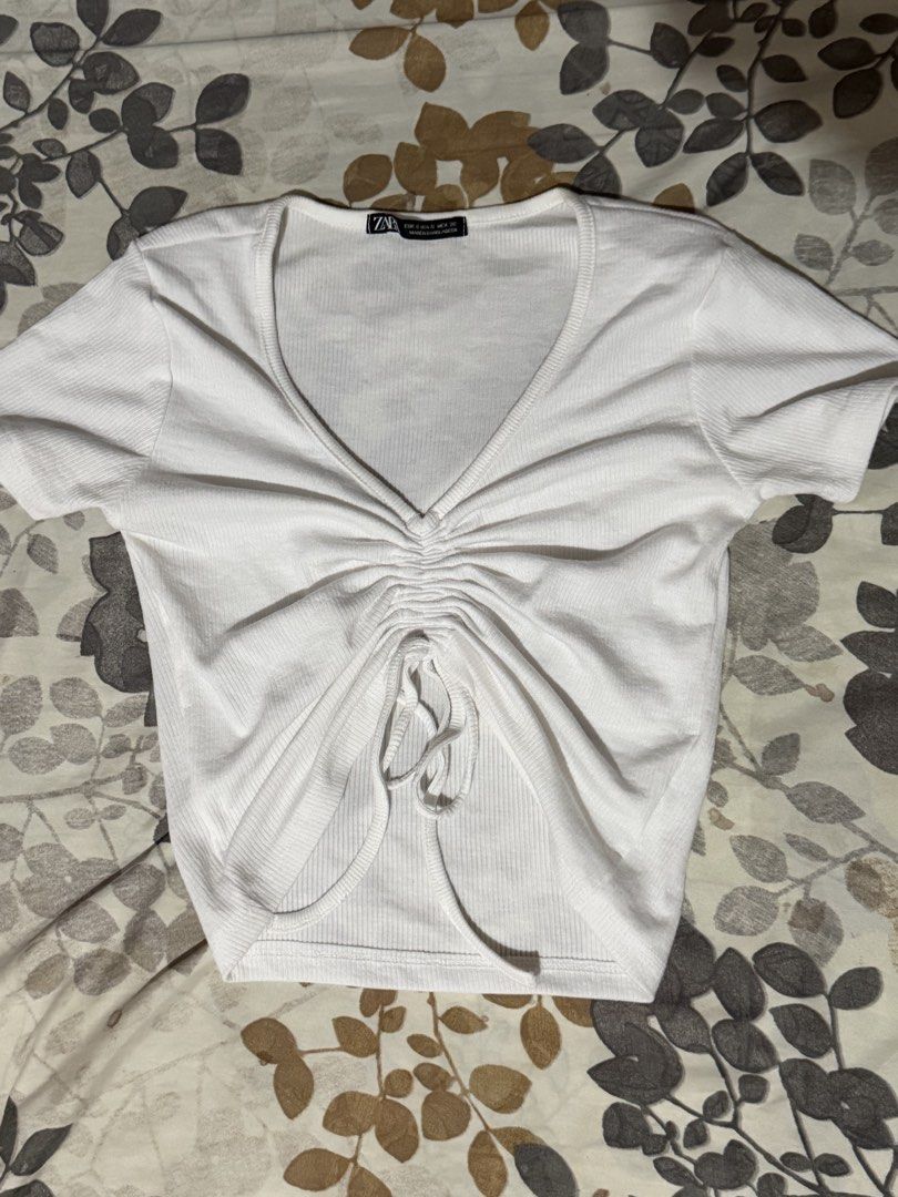 Zara White Ruched V-Neck Crop Top (Category: Blouses) located in Taytay. Submitted by cloudy_20 (Listing ID 1462153449, Image 1). Description: - White ribbed crop top from Zara - V-neck with adjustable drawstring ruching - Short sleeves - Trendy and easy to style with jeans or skirts.