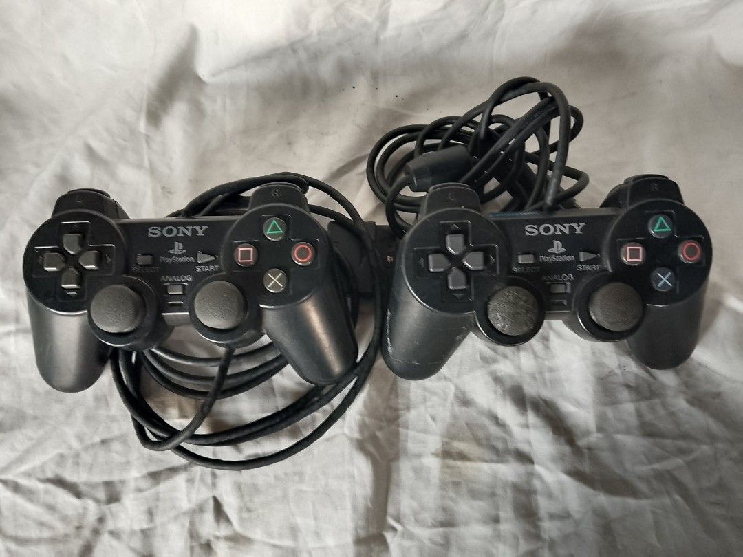 2x Sony PlayStation DualShock 2 Controllers (Category: Controllers) located in Quezon City. Submitted by jpnvintageonline (Listing ID 1462264202, Image 1). Description: - Two (2) Black Sony PlayStation DualShock 2 Controllers - Wired connection for reliable gameplay - Classic PlayStation button layout - As is Untested condition .