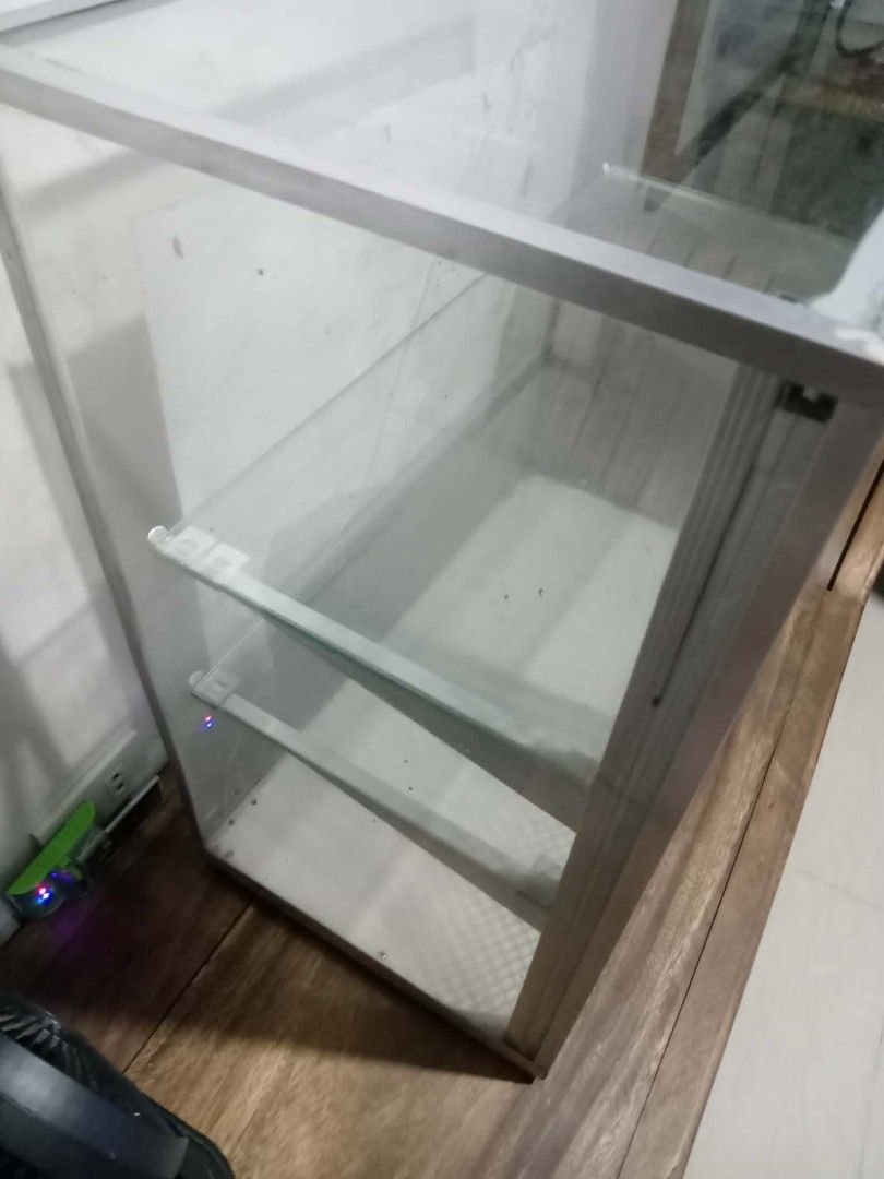 3 Aluminum Layer Food Cabinet (Category: Shelves, Cabinets & Racks) located in Quezon City. Submitted by northfacered (Listing ID 1462324594, Image 3). Description: - Sleek glass and aluminum display cabinet - Features two (2) internal glass shelves - Front sliding mesh doors for easy access and display - Ideal size for tabletop or shelf placement - Perfect for showcasing collectibles, trinkets, or small items.