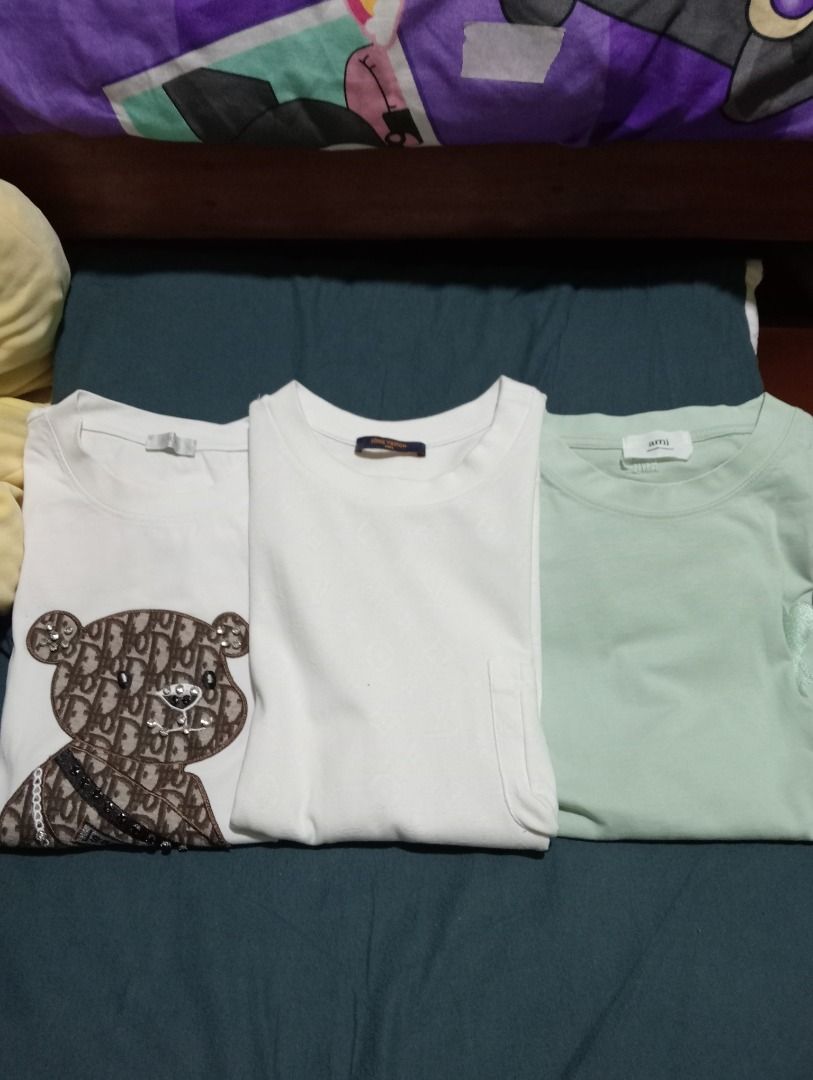 3 T-shirts: Dior Bear, LV Monogram, Ami Paris (Category: Shirts) located in Caloocan City. Submitted by yazzielux (Listing ID 1462432907, Image 1). Description: - White tee featuring a cool Dior-style bear graphic. - White tee with an all-over Louis Vuitton monogram pattern. - Light green Ami Paris t-shirt. - Essential basics to elevate your everyday style..