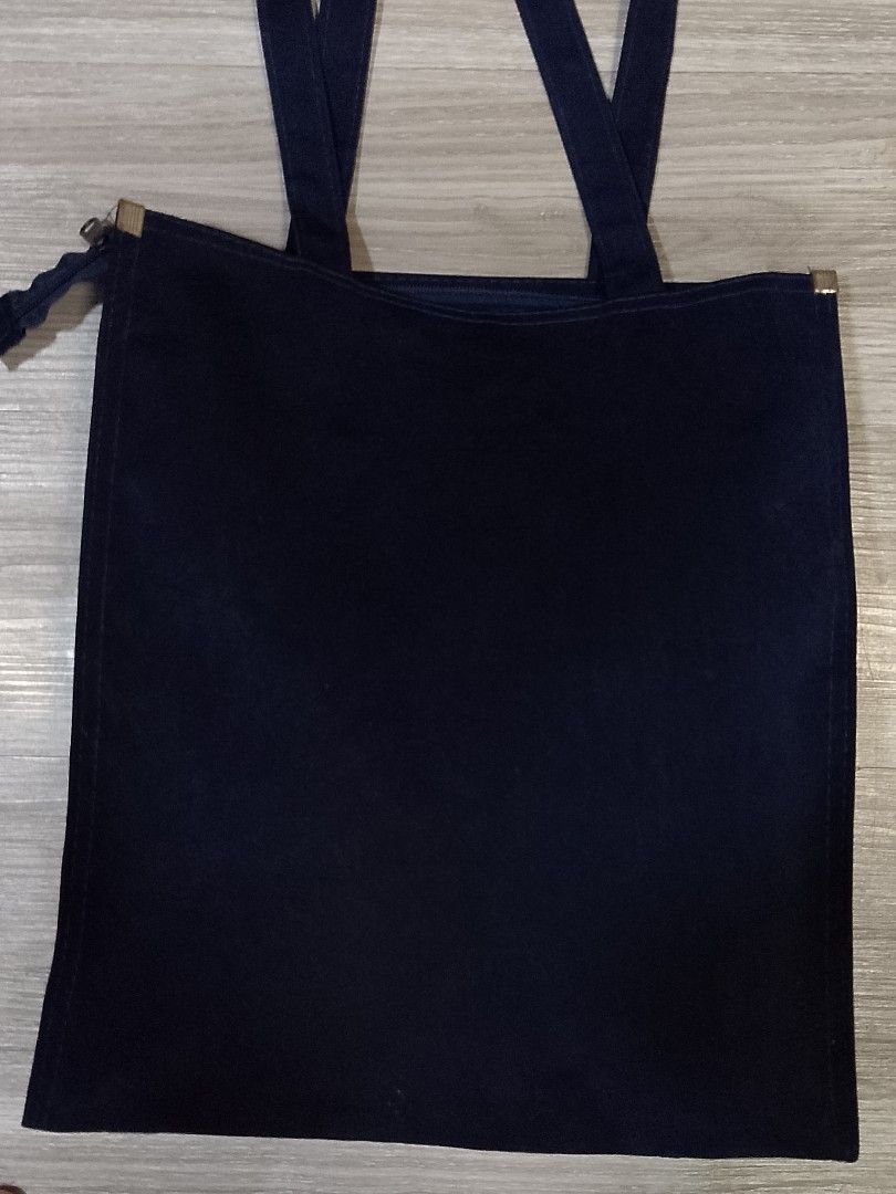 A plain vertical black canvas tote bag (Category: Tote Bags) located in Caloocan City. Submitted by pvaliao (Listing ID 1462363301, Image 2). Description: A plain vertical black canvas cotton tote bag with two shoulder straps resting flat. Fabric: cotton canvas Size: 12 inches × 14 inches Price: 100 Pre-owned Buy it now!.