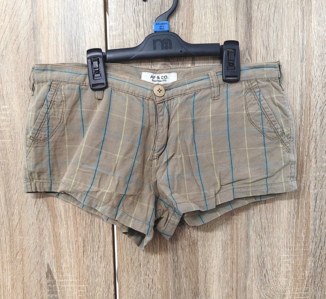 Abercrombie & Fitch Plaid Shorts (Category: Shorts) located in Las Pinas. Submitted by offtonewhome (Listing ID 1462266876, Image 1). Description: - Brand: Abercrombie & Fitch - Color: Brown plaid - Closure: Button and zip - Pockets: Two back pockets with button details - Fabric: Subtle textured - Style: Casual wear.