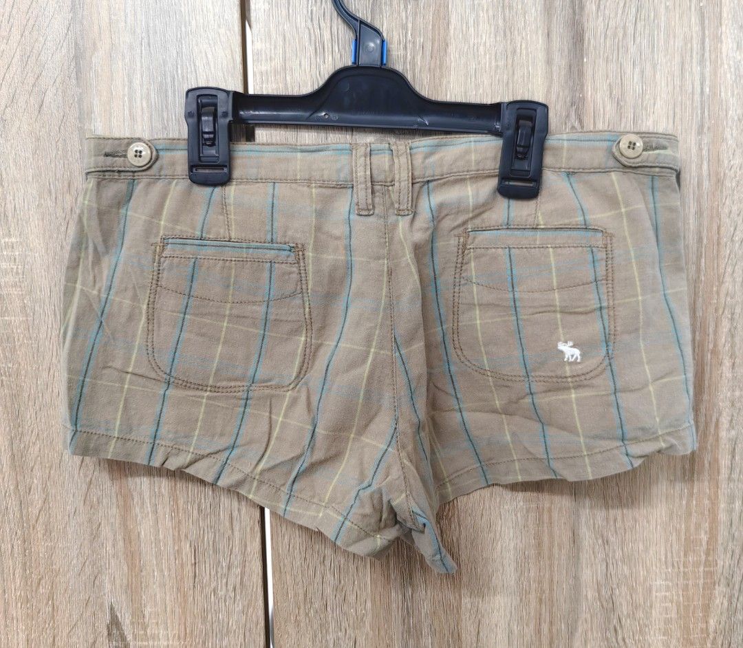 Abercrombie & Fitch Plaid Shorts (Category: Shorts) located in Las Pinas. Submitted by offtonewhome (Listing ID 1462266876, Image 2). Description: - Brand: Abercrombie & Fitch - Color: Brown plaid - Closure: Button and zip - Pockets: Two back pockets with button details - Fabric: Subtle textured - Style: Casual wear.