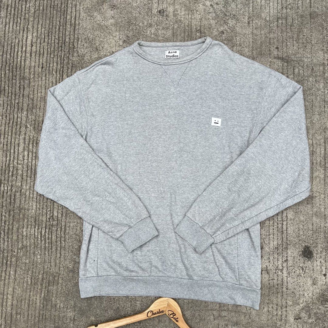 Acne Studios Grey Face Logo Sweatshirt (Category: Coats, Jackets and Outerwear) located in Davao. Submitted by charlesole52665 (Listing ID 1462317116, Image 1). Description: - Grey Acne Studios sweatshirt - Size: Fit Up to XL - Width: 24 inch - Length: 29 inch -Issue: Need wash - Features iconic face logo on chest - Crewneck style with long sleeves - Ribbed cuffs and hem for a snug fit - Made from a comfortable cotton blend - Ideal for everyday c