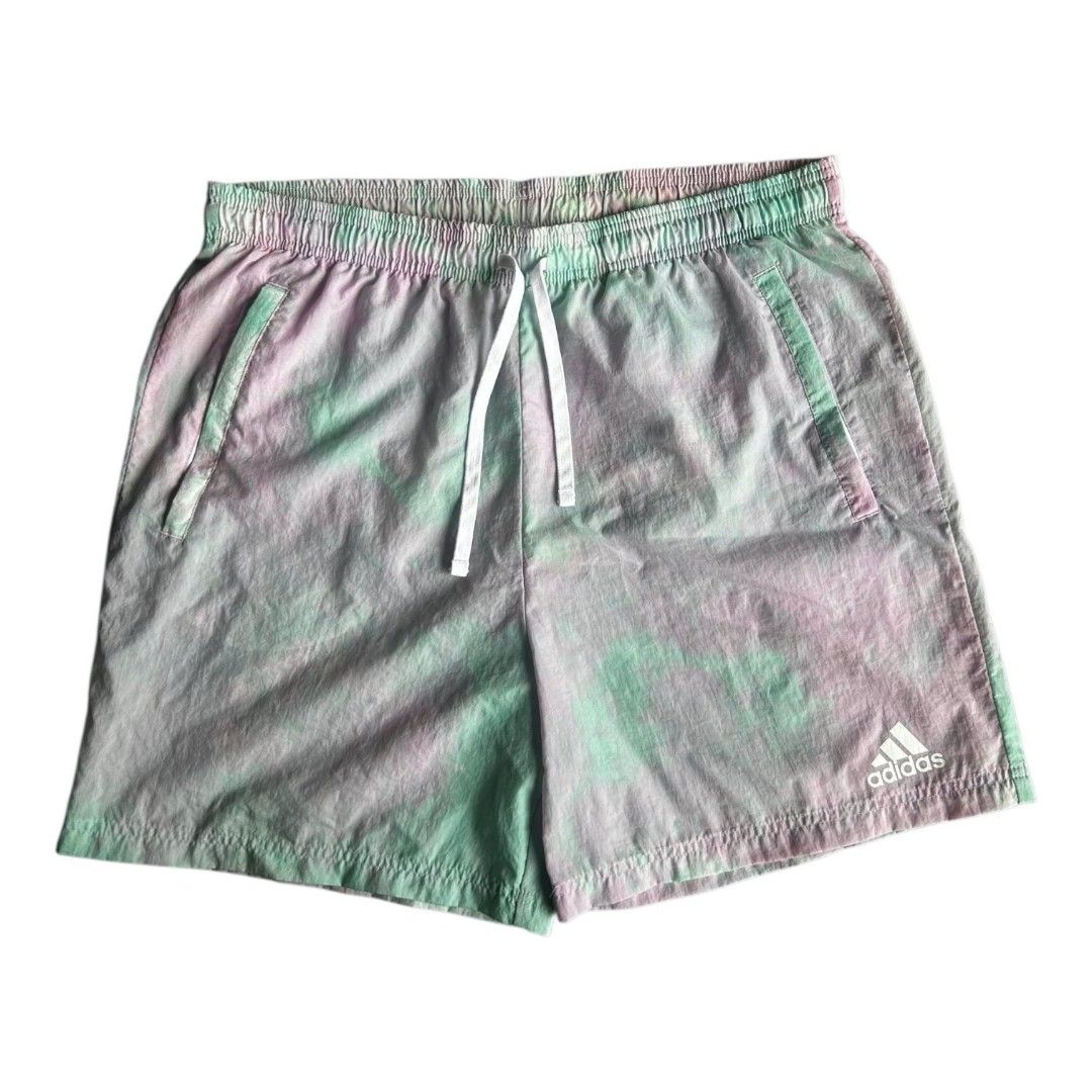Adidas Essential Shorts (Category: Activewear) located in Dumaguete. Submitted by mastermasto (Listing ID 1462439673, Image 1). Description: - Fits 32-36 - Adidas shorts with a unique purple and green tie-dye pattern. - Comfortable elastic waistband with an adjustable white drawstring. - Features convenient pockets, including one with a zipper for secure storage. - Versatile for everyday casual wear or athletic activities..