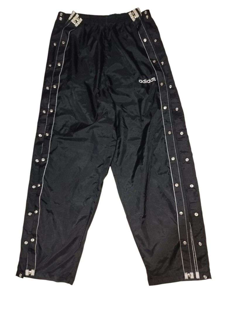 Adidas Tearaway Track Pants (Category: Joggers) located in Quezon City. Submitted by y2k_thriftkid (Listing ID 1462276696, Image 2). Description: - Classic Adidas tearaway track pants - Color: Black with white stripes - Full snap buttons on both legs for easy on/off - Elastic waistband with drawstring - Ideal for sports or casual wear.