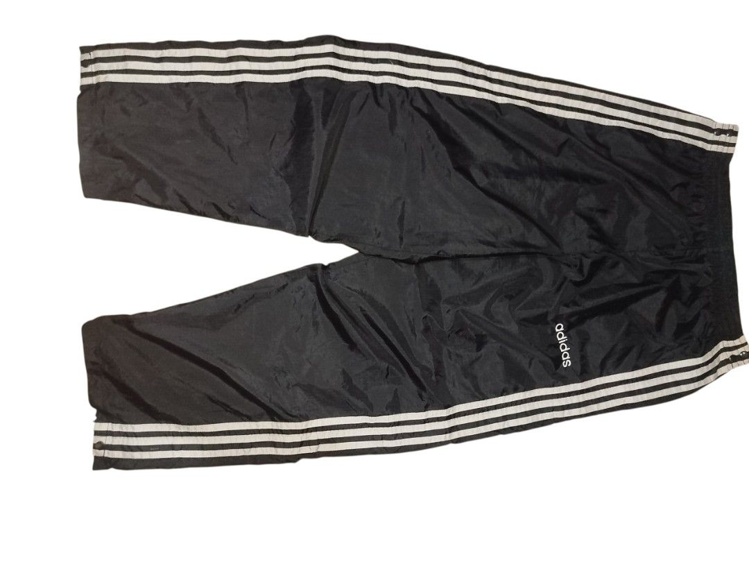 Adidas Tearaway Track Pants (Category: Joggers) located in Quezon City. Submitted by y2k_thriftkid (Listing ID 1462276696, Image 1). Description: - Classic Adidas tearaway track pants - Color: Black with white stripes - Full snap buttons on both legs for easy on/off - Elastic waistband with drawstring - Ideal for sports or casual wear.