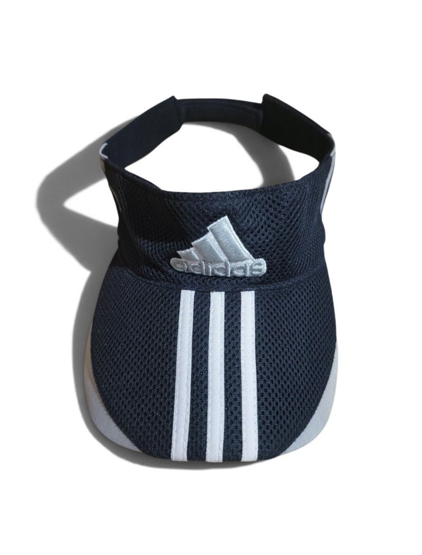 Adidas Visor Cap Hat 3-Stripes Mesh Adjustable (Category: Caps & Hats) located in Talisay. Submitted by rubiobryle20102 (Listing ID 1462389238, Image 2). Description: - Adidas visor - Color: Dark blue with white 3-stripes and logo - Material: Breathable mesh - Features: Adjustable strap at the back - Ideal for: Sports, sunny days - Condition: Clean and ready to wear 380 Free shipping📥.