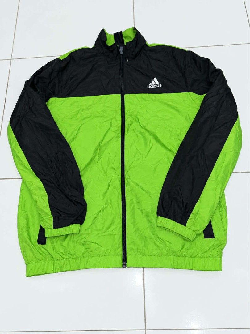 Adidas Windbreaker Jacket Green Black (Category: Coats, Jackets and Outerwear) located in Bulacan. Submitted by annenicathriftthriftlang (Listing ID 1462322479, Image 1). Description: - Adidas jacket in green and black - Full zip front closure - Adidas logo on the front - Large Adidas logo graphic on the back - Lightweight material - Ideal for casual wear or sports activities.
